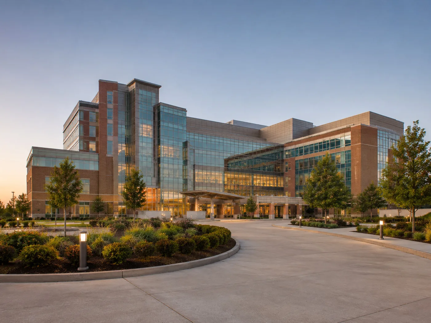 A modern hospital campus at dusk.